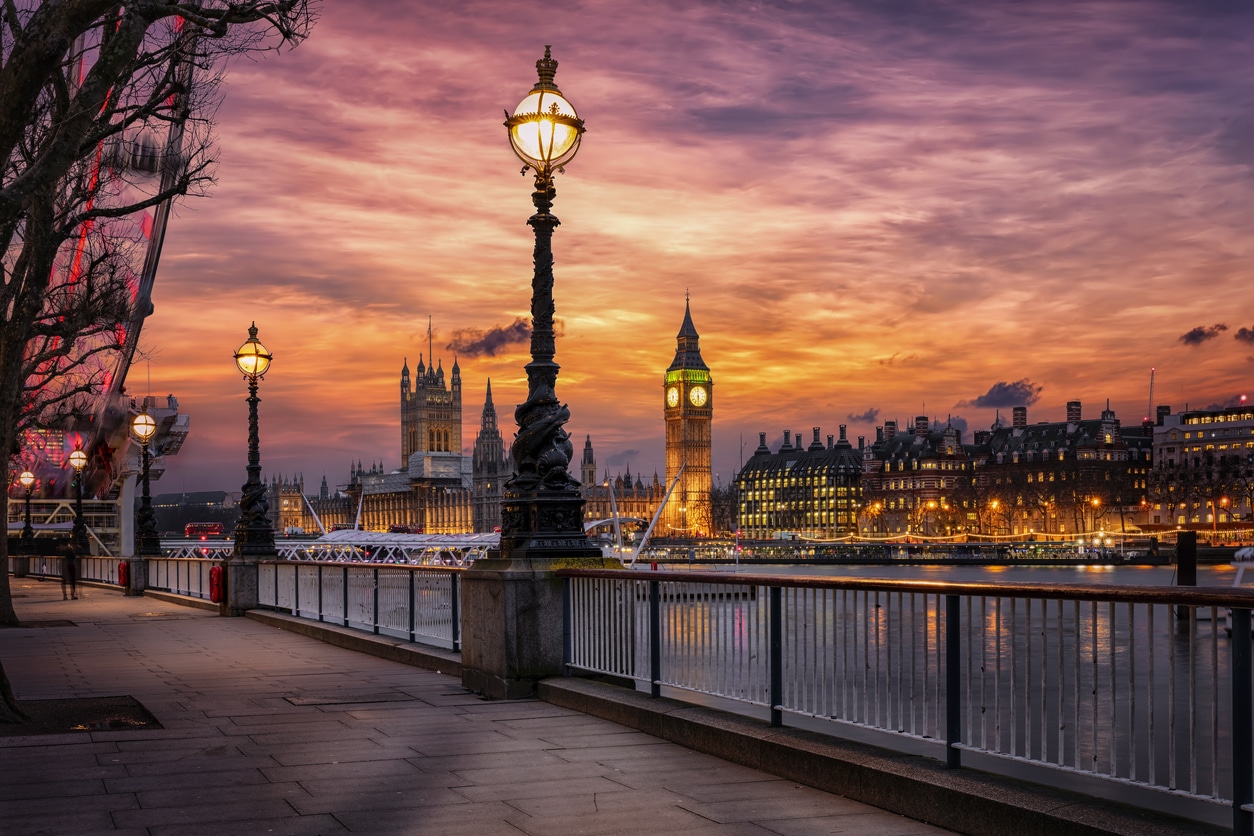 The London southbank riverside of the Thames with view to the Big Ben clocktower and Westminster Palace during a colorful sunset, United Kingdom
